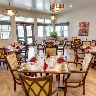 A well-arranged dining room with neatly set tables and elegant decor.