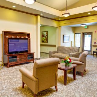 A cozy living room with comfortable seating and a large television.