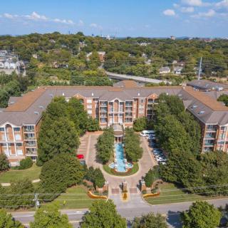 Aerial view of a large apartment complex surrounded by trees and greenery.