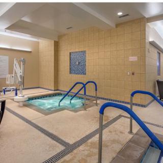 An indoor spa area featuring a hot tub and relaxation amenities.
