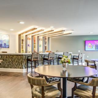 A modern lounge bar with stylish seating and a television display.