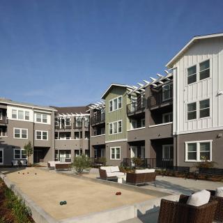 Modern apartment complex with outdoor seating area.