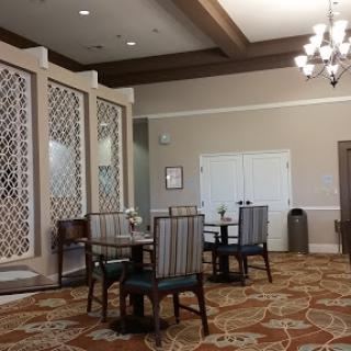 A well-furnished dining area featuring elegant tables and chairs, complemented by decorative elements and ambient lighting.
