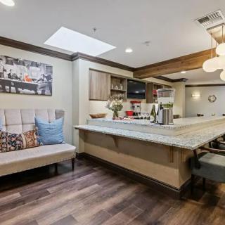 A modern kitchen interior with an island and cozy seating.