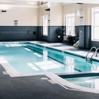An indoor swimming pool with modern design and natural lighting.