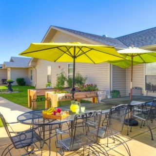 A sunny patio area with outdoor seating and bright yellow umbrellas.