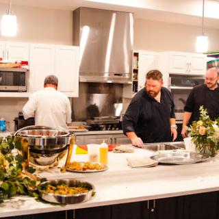 Chefs preparing a gourmet meal in a modern kitchen.