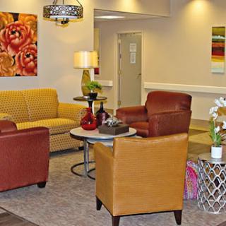 A cozy lounge area featuring colorful seating, modern decor, and vibrant artwork.