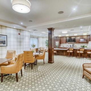 A modern dining area with comfortable seating and a bar.