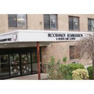 Entrance to a healthcare and rehabilitation center with visible signage.