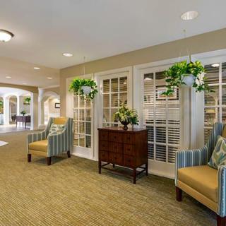 A cozy lobby area with seating and potted plants.