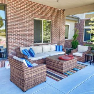 A cozy outdoor seating area featuring a comfortable sofa and chairs, perfect for relaxation.