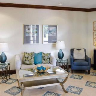 A stylish living room with a cozy sofa, armchair, and elegant decor.