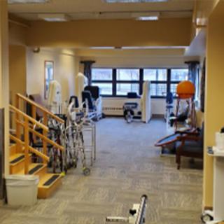 A physical therapy room equipped with various rehabilitation and exercise machines.