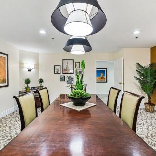 A stylish dining room with modern lighting and elegant furniture.
