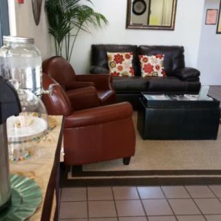 A cozy waiting room with comfortable seating and a coffee station.