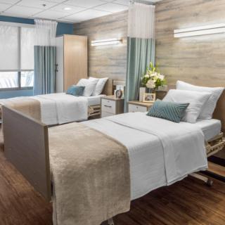 A well-organized hospital room with two beds and modern decor.