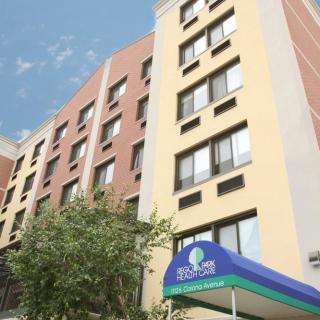 A view of a multi-story hotel building with a colorful awning at the entrance.