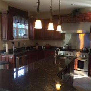 A modern kitchen with elegant lighting and high-end appliances.