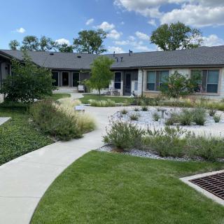 A modern house with well-maintained landscaping and a garden path.