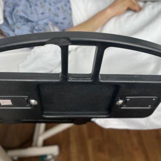 A patient lying in a hospital bed with a view of the footboard.