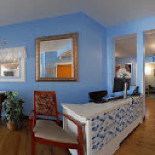 A bright and welcoming office reception area with blue walls and tasteful decor.
