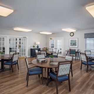 A bright and modern dining area with wooden floors and stylish furniture.