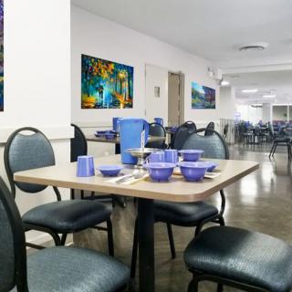 A neatly set dining area with tables and chairs, ready for guests.