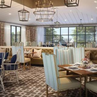 A modern restaurant dining area featuring elegant seating and stylish lighting.