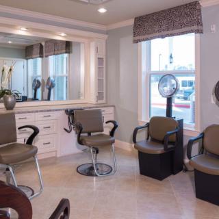 A cozy hair salon interior with styling chairs and mirrors.