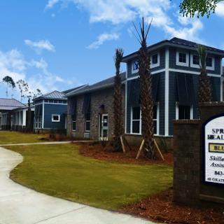 A modern residential building with well-maintained landscaping and clear signage.
