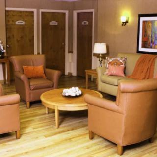 Cozy waiting room with comfortable seating and warm lighting.
