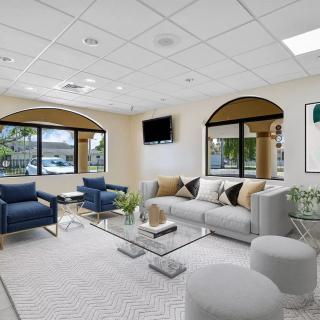 Spacious and modern living room with comfortable seating and large windows.