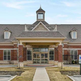 A brick building with a grand entrance and symmetrical design.