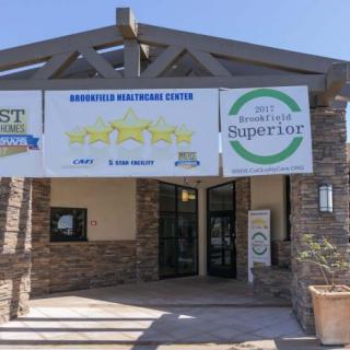 Exterior view of a healthcare center with banners displaying awards and ratings.