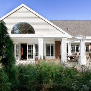 A charming house with a garden and patio area.