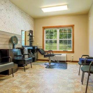 A well-lit hair salon with styling stations and chairs.