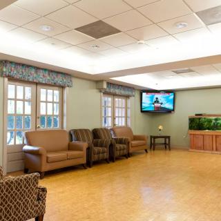 A comfortable indoor seating area with a television and fish tank.