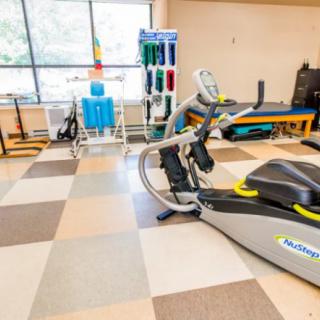 A rehabilitation center with exercise equipment and treatment areas.