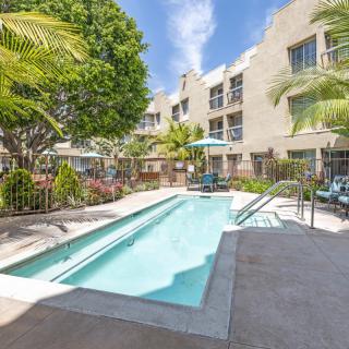 A sunny day by the pool in a modern apartment complex.