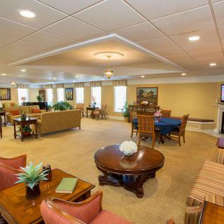 A spacious and well-furnished living room with various seating arrangements and decor.