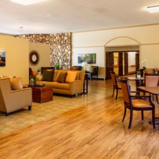 A cozy lobby with comfortable seating and wooden flooring.