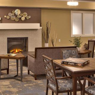 A warm and inviting living area featuring a fireplace, comfortable seating, and modern decorations.