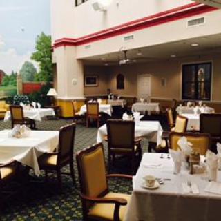 An elegant restaurant dining area with neatly arranged tables and chairs.