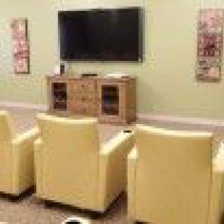 A cozy home theater setup with comfortable seating and a large television.