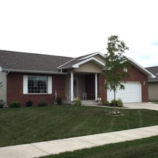 A charming suburban home with a well-maintained lawn and inviting entrance.
