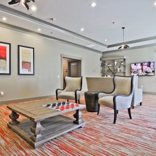 A modern lobby with stylish furniture and artwork on the walls.