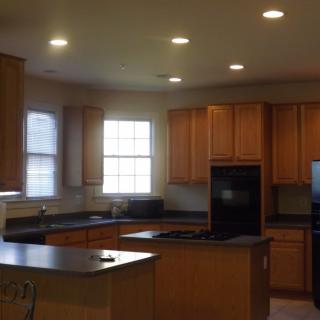 A spacious kitchen with wooden cabinets and a central island.