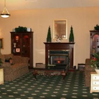 A cozy living room with a fireplace and classic furniture.