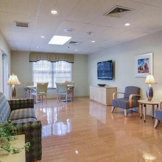 A bright and cozy living room with modern furniture and a large television.